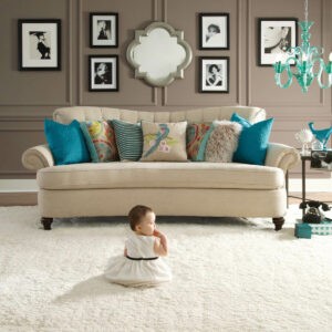 Cute baby sitting on carpet floor | Cleveland Carpets and Floors