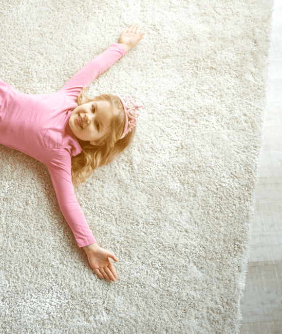 Cute girl laying on rug | Cleveland Carpets and Floors